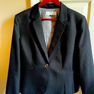 Black pinstriped matching skirt suit with one button blazer.